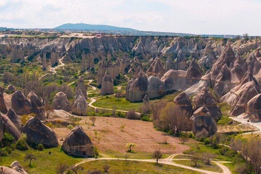 A landscape with numerous rock formations and a winding road. 3