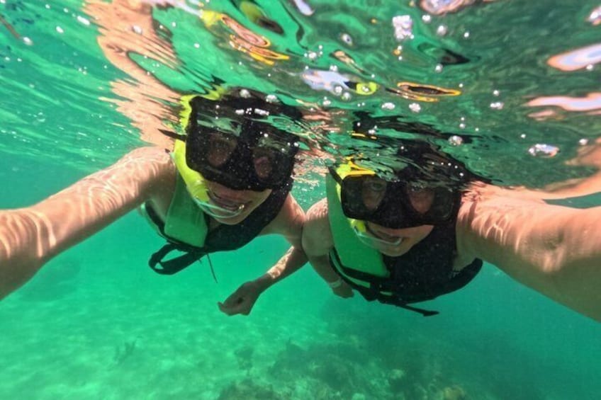 Two people scuba diving underwater. 1