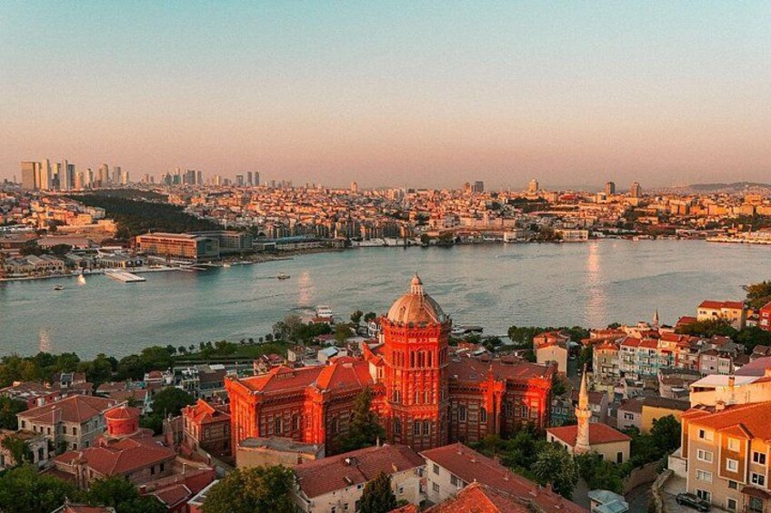 A cityscape with a prominent church with a red dome, a river, and a skyline with buildings. 4