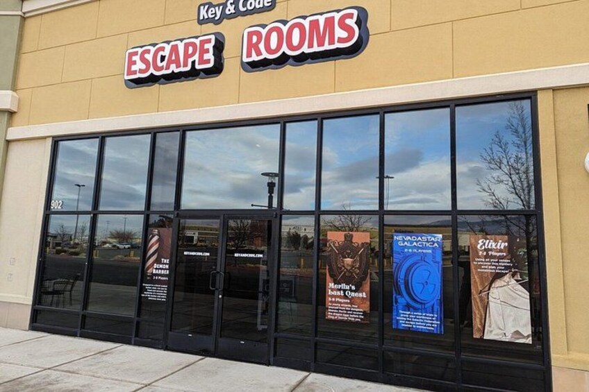 A storefront with large windows and a sign that reads 'Escape Rooms.' 2