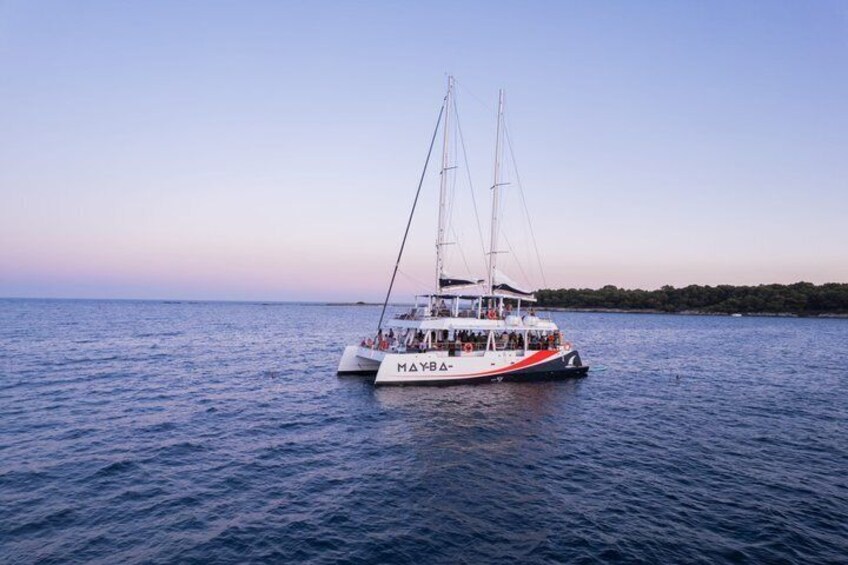 A sailboat named 'MAYB' on calm waters with a clear sky. 4
