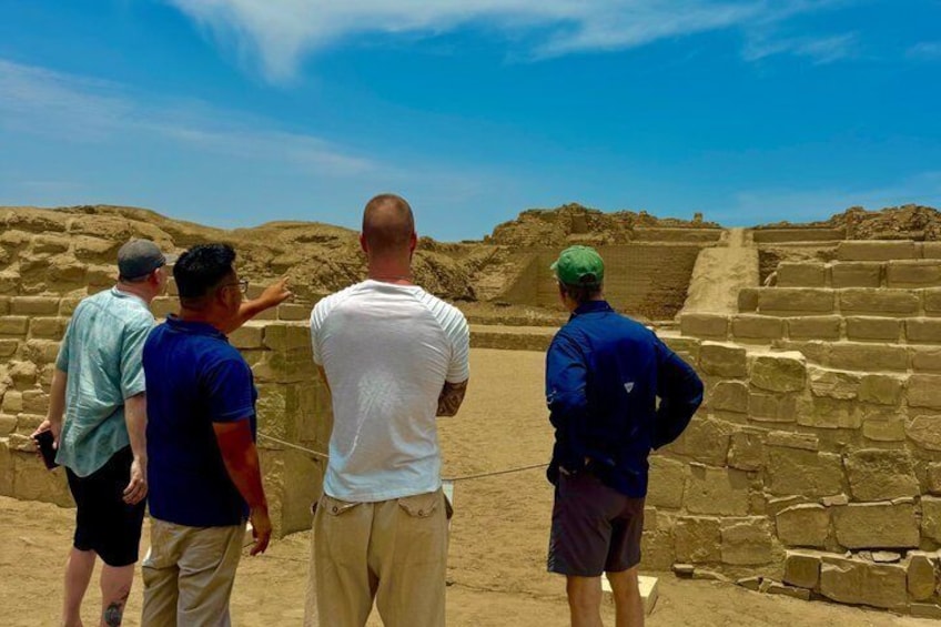A group of people observing ancient stone structures. 4
