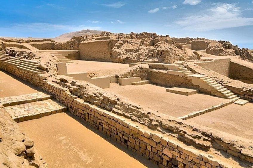 Ancient ruins with stepped structures and stone walls. 1