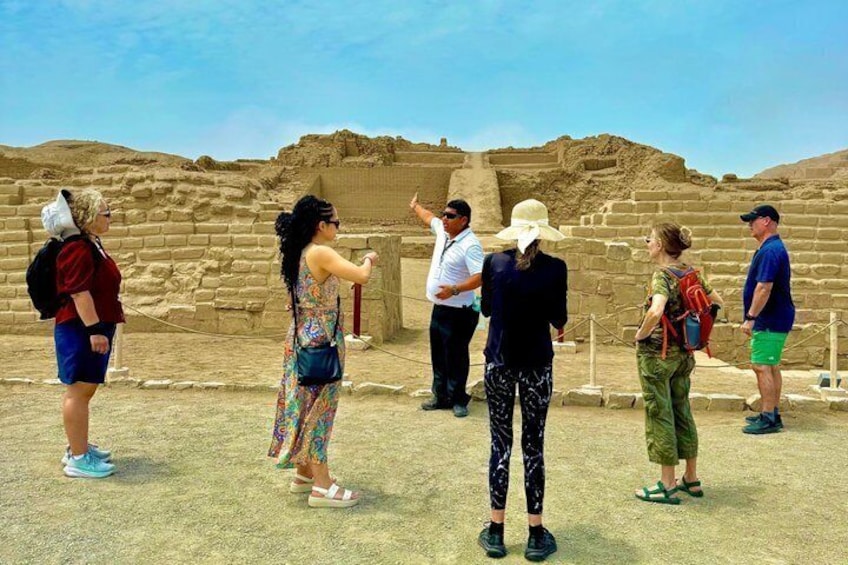 Tourists at an archaeological site with ancient ruins. 1