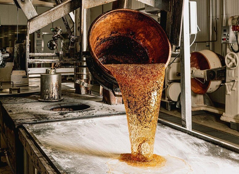A copper vat in a factory with a pouring spout. 5