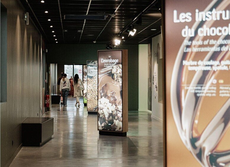A corridor with a chocolate-themed display and informational posters. 1