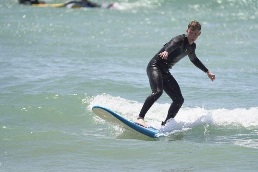 A person surfing on a wave in the ocean. 4