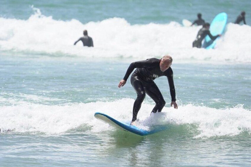 A surfer riding a wave on a blue surfboard. 2