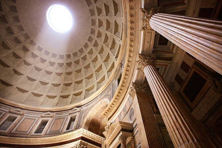 A grand architectural interior with a domed ceiling, ornate columns, and detailed moldings. 2