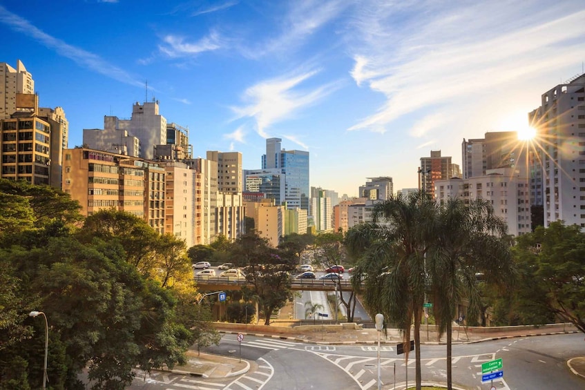 A cityscape with modern buildings, a roundabout, and a clear sky. 3