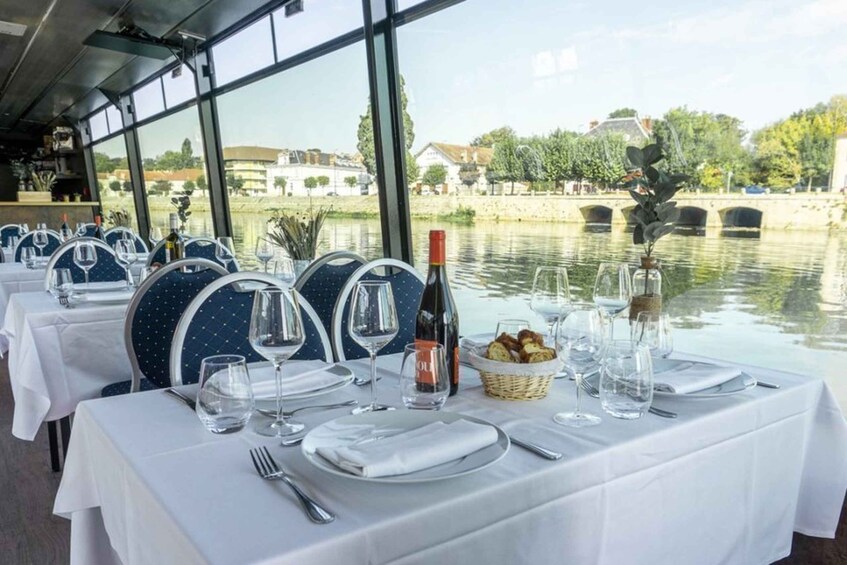 A table set for dining with a view of a river and buildings in the background. 5
