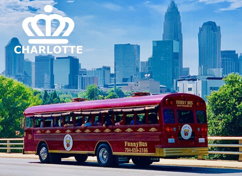 A red bus with 'Funny Bus' branding and a phone number on the side, driving on a road with a city skyline in the background. 2