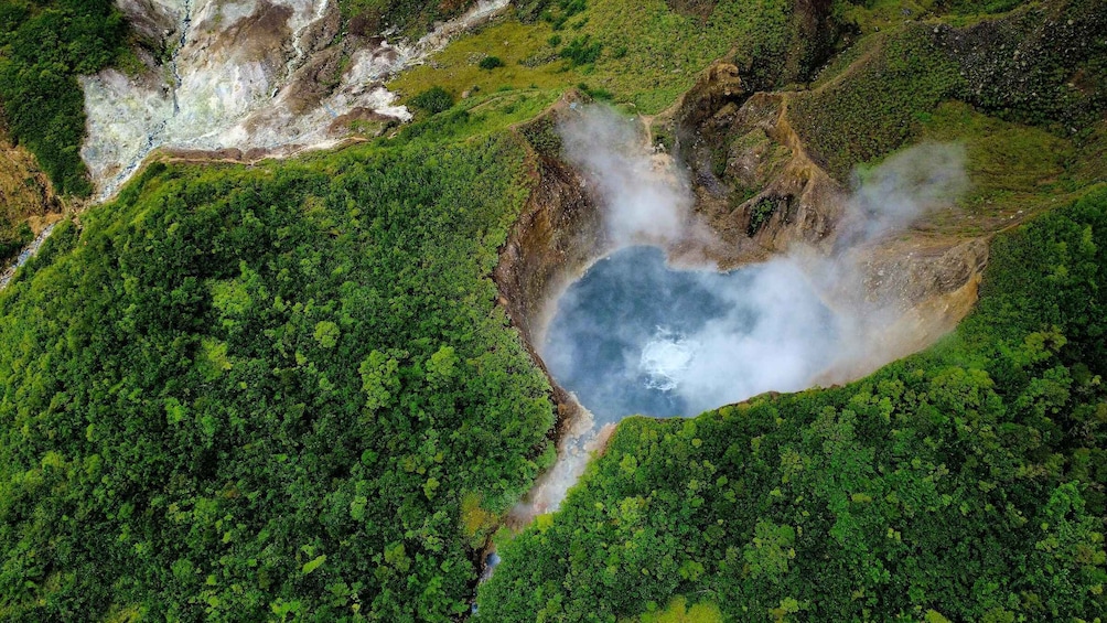 A volcanic crater surrounded by dense green forest. 5