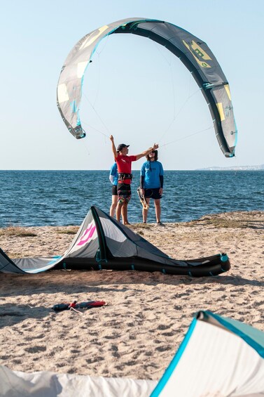 Two people on a beach with a kite. 3