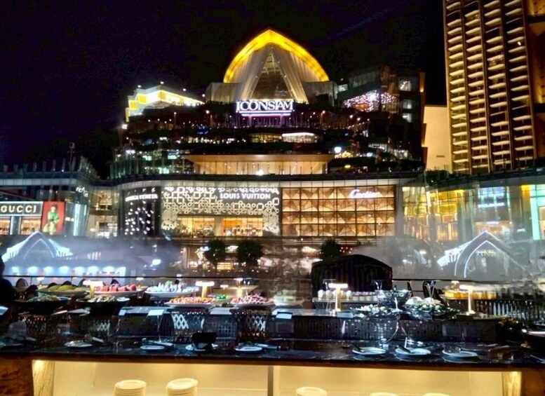 A brightly lit building with the 'Louis Vuitton' logo, surrounded by other illuminated storefronts. 5