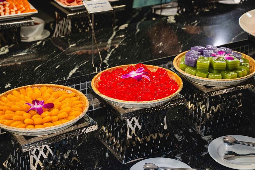 A dessert display with various colorful dishes. 3
