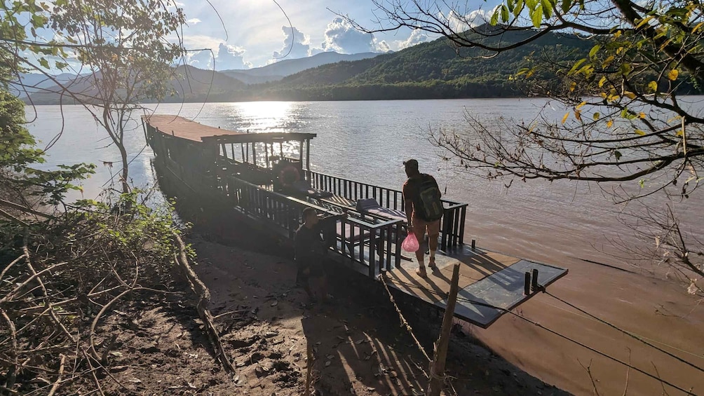 A dock extending into a calm lake with a mountainous backdrop. 2