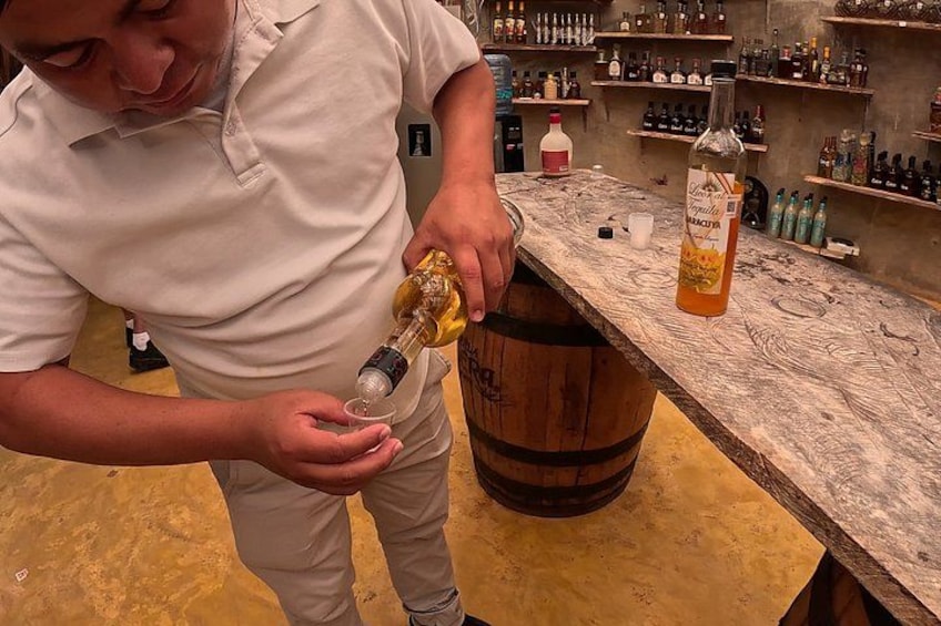 A person pouring a drink into a glass. 5