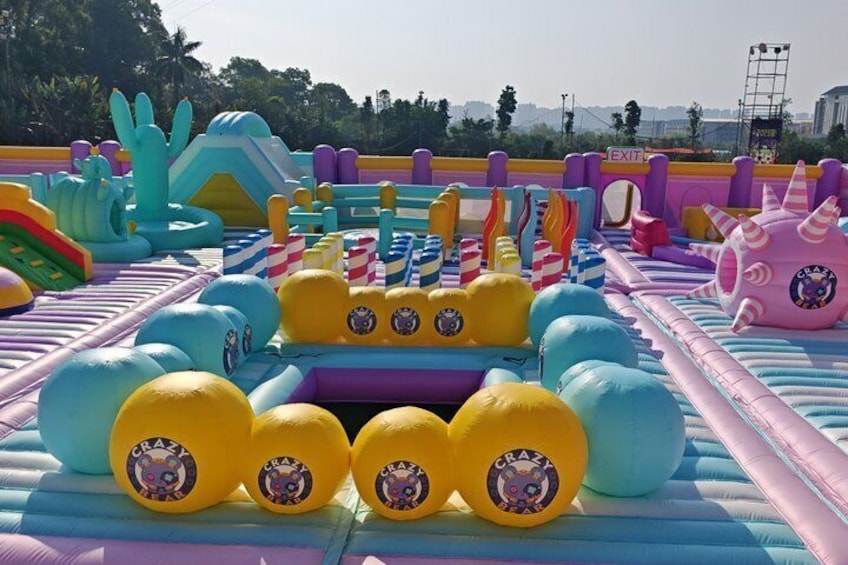 An inflatable play area with slides, a ball pit, and various colorful structures. 4