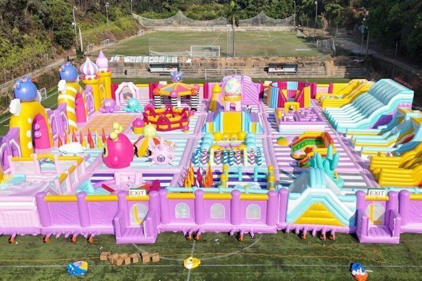A colorful inflatable play area with slides and climbing structures. 1