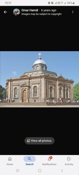 A large, historic building with a dome and arched windows. 5
