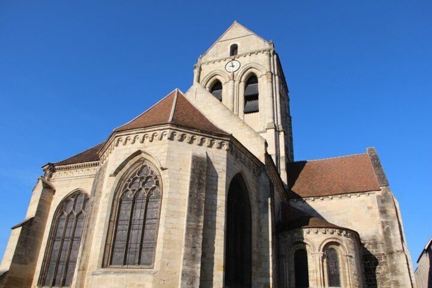 A historic church with a prominent clock tower and large arched windows. 4