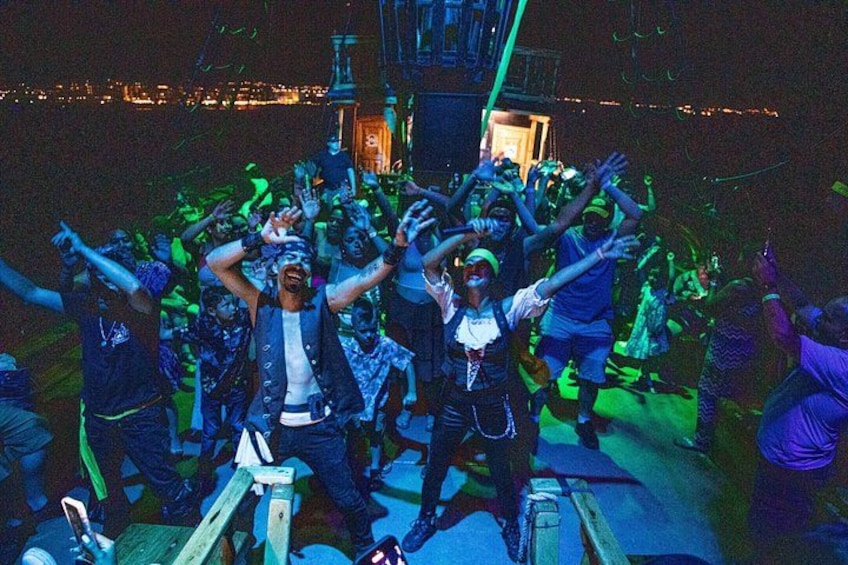 A group of people dancing on a stage with a cityscape in the background. 2