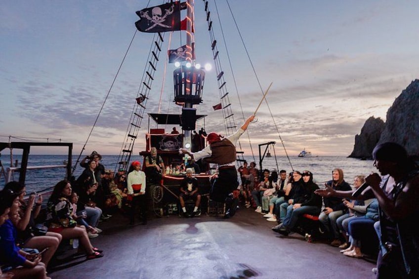 A pirate-themed event on a boat with a crowd watching. 3