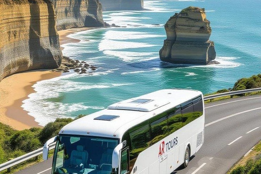 A tour bus driving on a coastal road with cliffs and a large rock formation in the background. 3