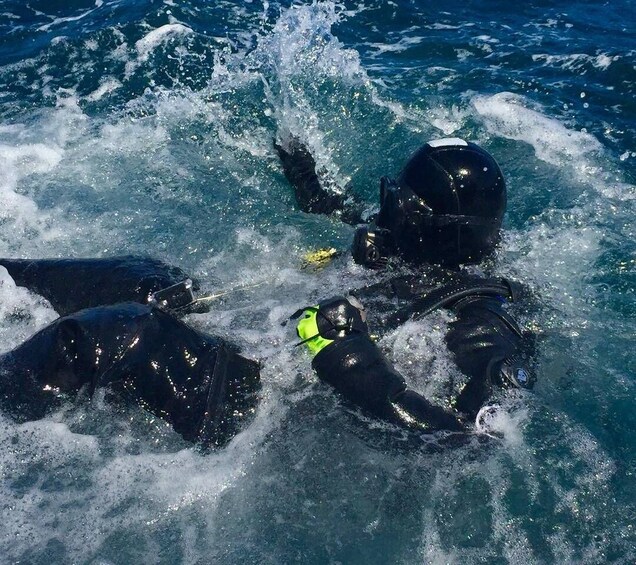 Two people scuba diving in the ocean. 3