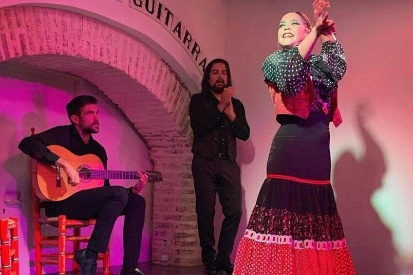 A person playing a guitar, another person singing, and a third person dancing. 3