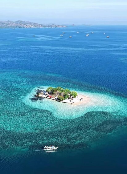 An aerial view of a tropical island surrounded by clear blue waters. 2