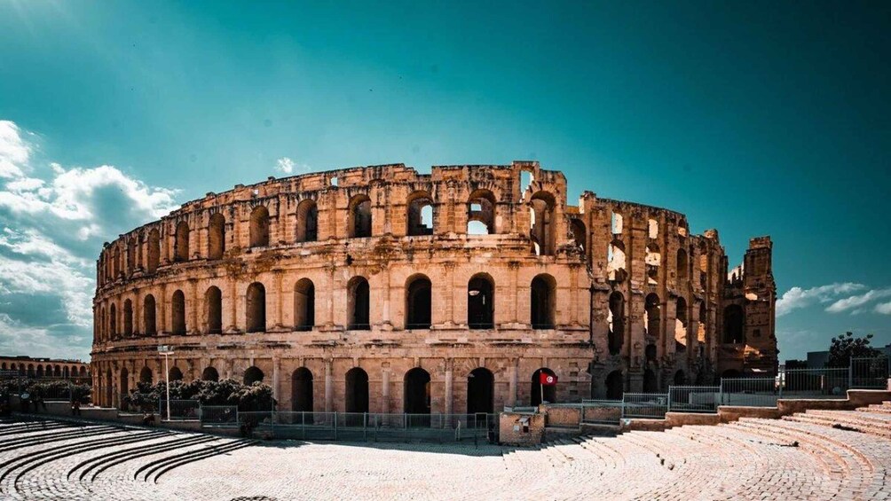 An ancient amphitheater with multiple arches and a circular layout. 2