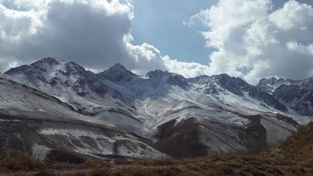 A snow-covered mountain range with rugged peaks and valleys. 5