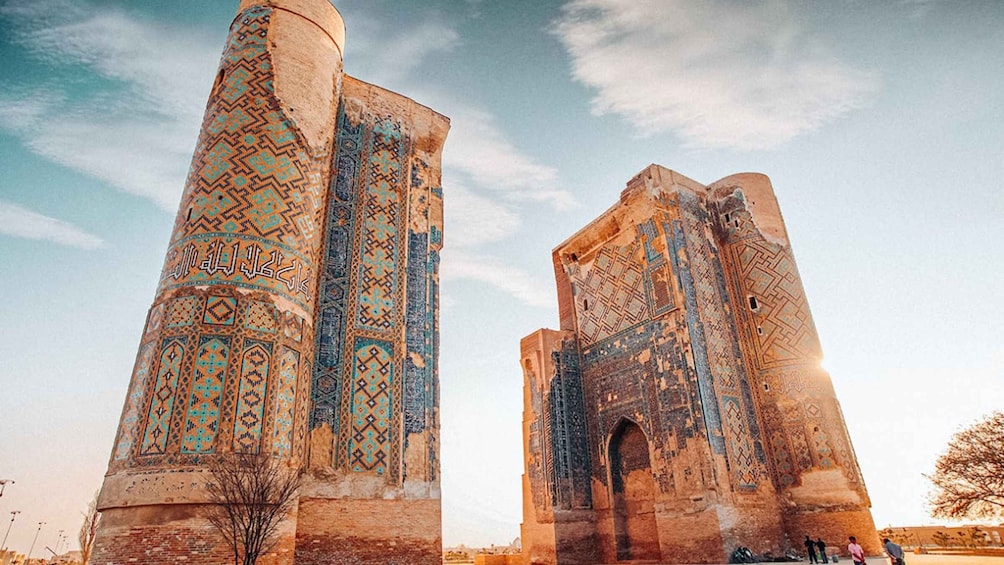 Two large, intricately patterned towers with a clear sky in the background. 1