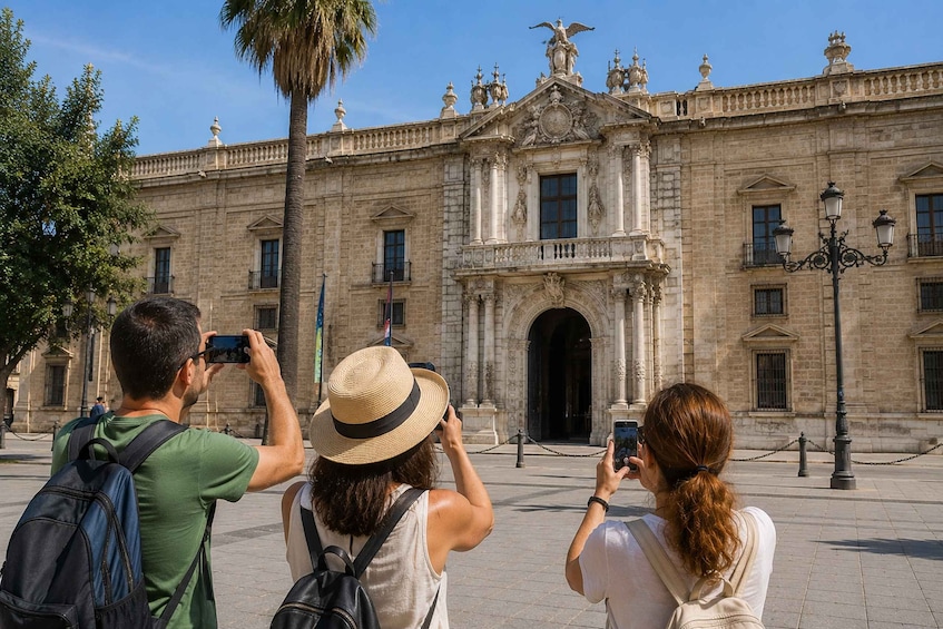 A historic building with ornate architecture, a palm tree, and people taking photos. 5