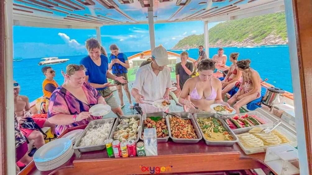 A group of people dining on a boat with a scenic ocean view. 5