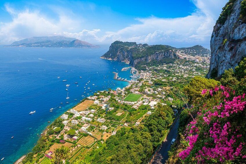 A coastal landscape with a village, cliffs, and the sea. 5