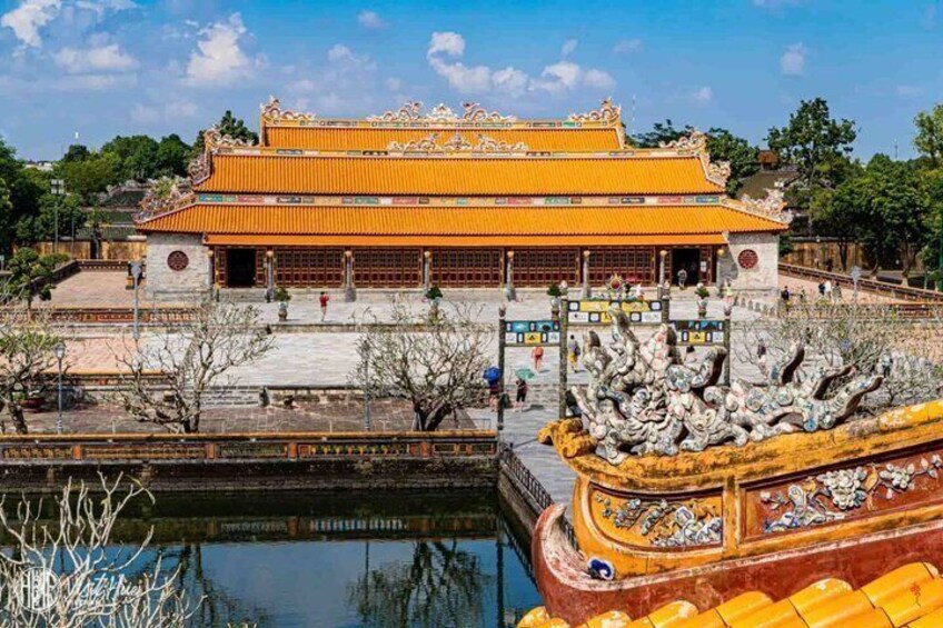 A traditional Chinese building with ornate architecture, a large courtyard, and a decorative boat. 2