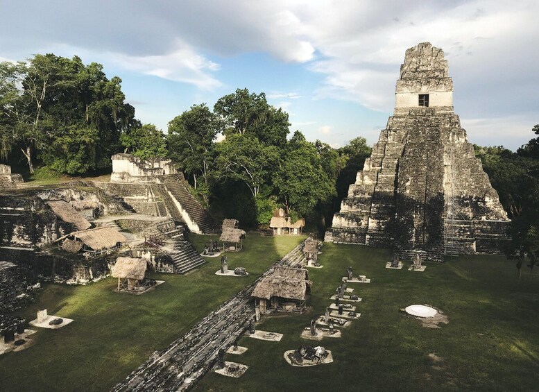 Ancient Mayan ruins with a large pyramid and stepped structures. 4