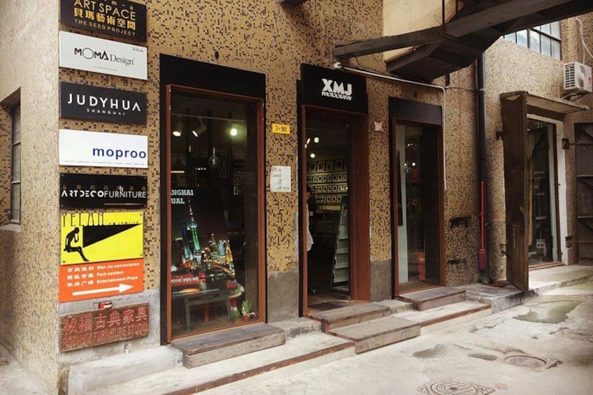 Storefronts with signage for various businesses, including a furniture store and a design studio. 5