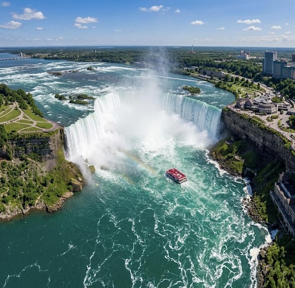 A large waterfall, a boat, and a cityscape with buildings and greenery. 2