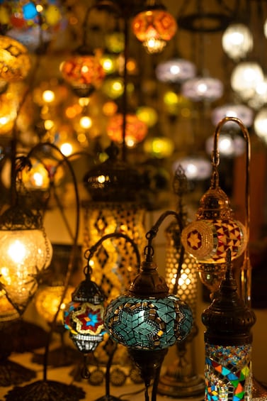 A collection of ornate, mosaic-adorned lanterns with warm lighting. 1