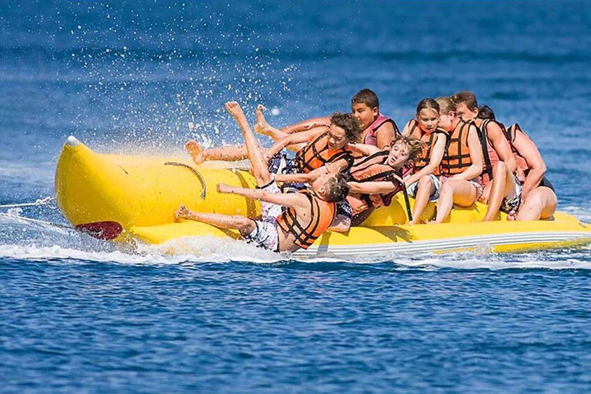 A group of people on a yellow raft in the water. 1