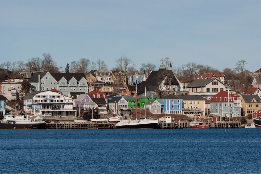 A waterfront town with colorful houses and a dock with boats. 4