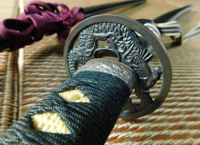 A close-up of a metallic, intricately designed key ring with a circular handle. 3