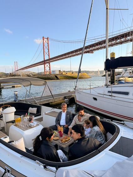 A group of people on a boat with a bridge in the background. 4