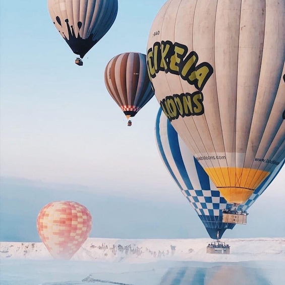 Hot air balloons with 'KIEKA LIONS' written on them flying over a snowy landscape. 5