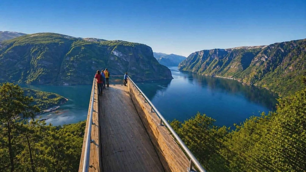 A wooden bridge over a river with steep cliffs on both sides. 1