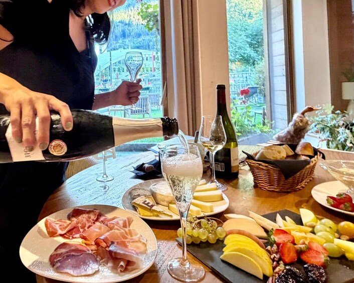A table with cheese, wine, and fruits. 3